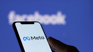 Meta logo on smartphone screen and Facebook logo  background : C