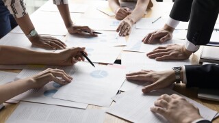 Hands of project managers discussing project management strategy