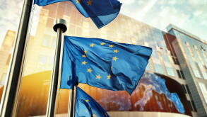 EU flags waving in front of European Parliament building. Brusse
