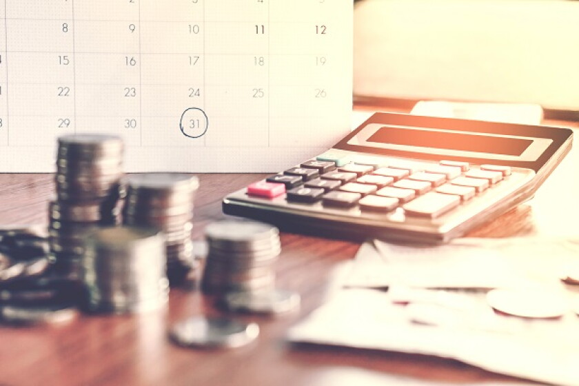  debt collection and tax season concept with deadline calendar remind note,coins,banks,calculator on table, background ,time to pay concept 
