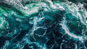 Abstract background. Waves of water of the river and the sea mee