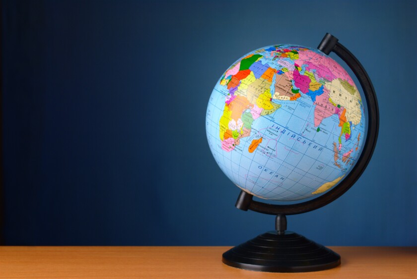 globe on a table against the wall of blue