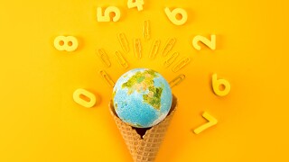 top view of earth globe in waffle cone surrounded with digits on