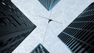 Man balancing on the rope high in the sky