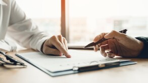 Business advisor financial man pointing on contract paper to customer reading contract.