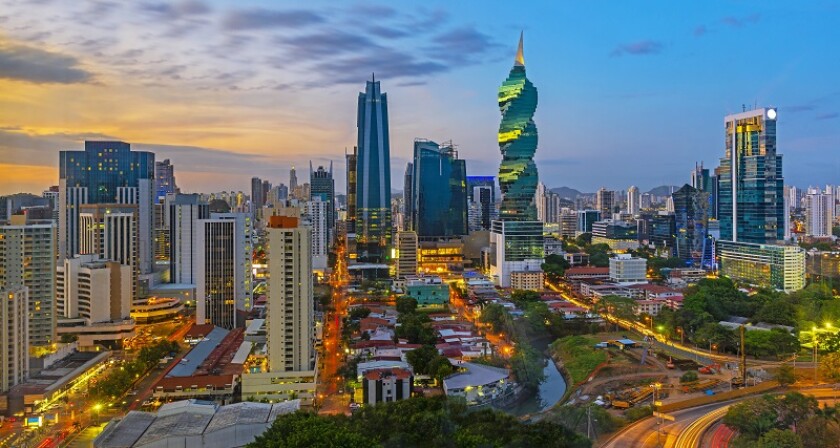 The colorful panoramic skyline of Panama City at sunset with high rise skyscrapers, Panama, Central America.