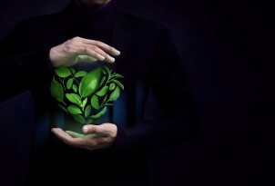 ESG Concept. Green Leaf as Heart Shape Protected by Gentle Gestu