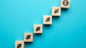 Us dollar growth concept and with icons on wooden blocks.