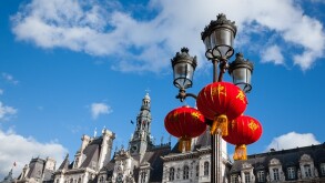 Paris celebrates Chinese New Year. Street light decorated with Chinese traditional red lanterns and Paris City Hall (Hotel de Ville) at backgrounds.