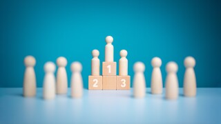 Business hierarchy, Wooden figures peg dolls standing on the podium 1st, 2nd, and 3rd positions of wooden cube blocks with copy space. Ranking and strategy concept. Success or ranking ideas.