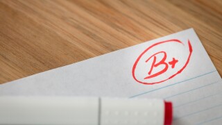 Good grade of B plus (B+) is written with red pen on the test.