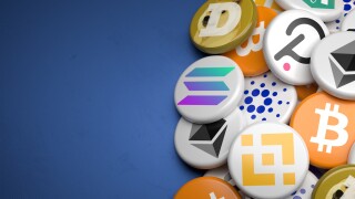 Logos of the main cryptocurrencies Bitcoin, Ethereum, Binance, Cardano, Ripple, Dogecoin, Tether, Solana, Polkadot on a heap on a table. Copy space. Web banner format