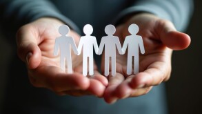 Hands holding paper cutouts of people holding hands. Concept of employee assistance programs support, care. Care for employees well-being, personal issues. Confidential support systems. Crisis