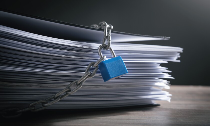 Documents locked with padlock and chains.