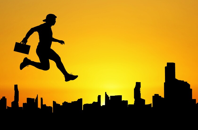 Silhouette of a man jumping in the meadow. The business concept 