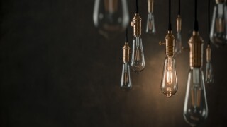 Individuality concept, one bright light bulb standing out from t