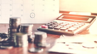  debt collection and tax season concept with deadline calendar remind note,coins,banks,calculator on table, background ,time to pay concept 