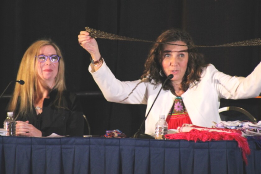 Esther Aburto Olague (right) showing a belt design that had been culturally appropriated 