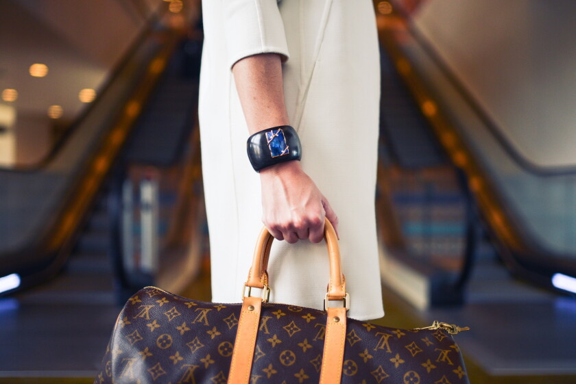 Person carrying a Louis Vuitton bag