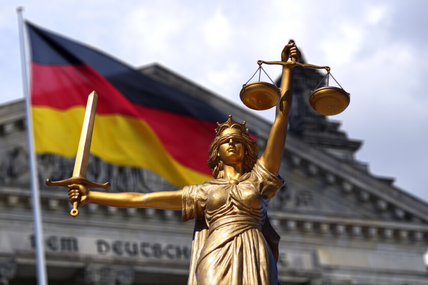Lady of Justice statue with German flag flying