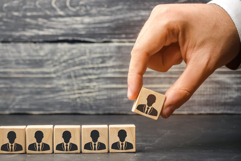 The leader builds team from cubes with employees. Businessman in search of new employees and specialists. personnel selection and management within the team. removes / dismisses the employee