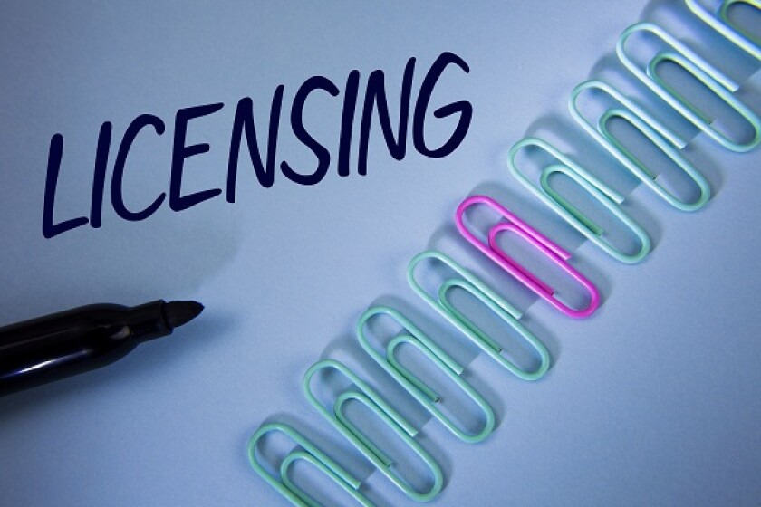 Word writing text Licensing. Business concept for Grant a license Legally permit the use of something Allow activity written on Plain Blue background Paper Clips and Marker next to it.