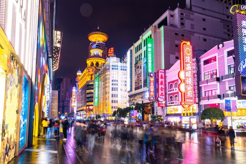 SHANGHAI, CHINA - DEC 22, 2019 : Nanjing Road is the main shopping streets of Shanghai, Neon signs light on Nanjing Road. The area is the main shopping one of the world's busiest shopping streets.