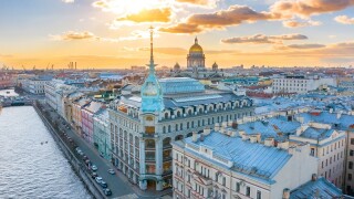 Department store shop class luxury, near the Red Bridge, historical buildings of Saint-Petersburg. In the background the city and St. Isaac's Cathedral dome of golden color, in the evening at sunset.