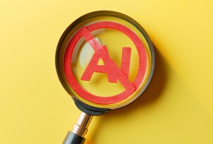 Magnifying glass showing forbidden artificial intelligence symbol on yellow background