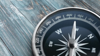 Brass antique compass  on background