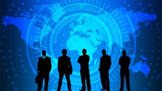 Silhouetted figures in front of a map of the world