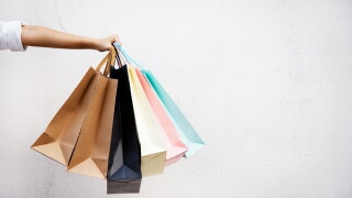 Shopping bags of women crazy shopaholic person at shopping mall.colorful paper shopping bags.
