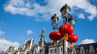 Paris celebrates Chinese New Year. Street light decorated with Chinese traditional red lanterns and Paris City Hall (Hotel de Ville) at backgrounds.