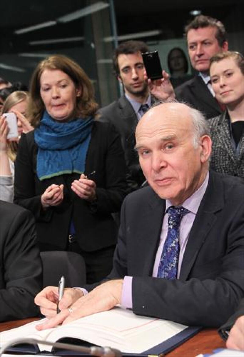 UK's Vince Cable signs