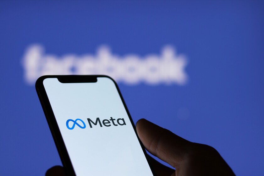 Meta logo on smartphone screen and Facebook logo  background : C