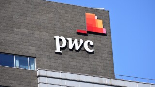 PWC PricewaterhouseCoopers logo, signage on the facade, audit and assurance, consulting and tax services company. WARSAW, POLAND - FEBRUARY 12, 2022