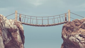 Old bridge over between two big rocks. 