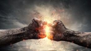 Fight, close up of two fists hitting each other over dramatic sk