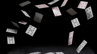 playing cards fall on a black table
