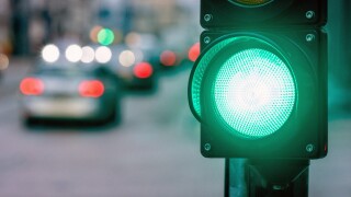 A city crossing with a semaphore. Green light in semaphore
