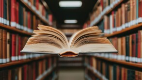Books floating in the air featuring bookshelves and surrealism concept. An open book floating in a library filled with bookshelves.