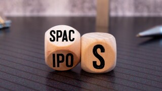 SPACs vs IPOs symbol. Cubes with words 'SPACs, special purpose acquisition companies' and 'IPOs