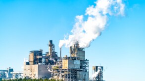 Industrial paper mill factory plant with chimney smokestacks sta