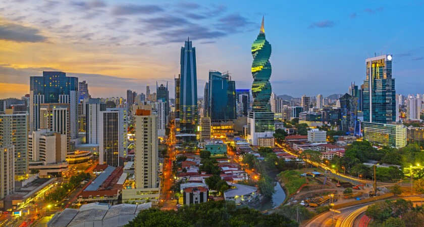 The colorful panoramic skyline of Panama City at sunset with high rise skyscrapers, Panama, Central America.