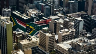 Johannesburg city centre with the South African flag on the sides of a building