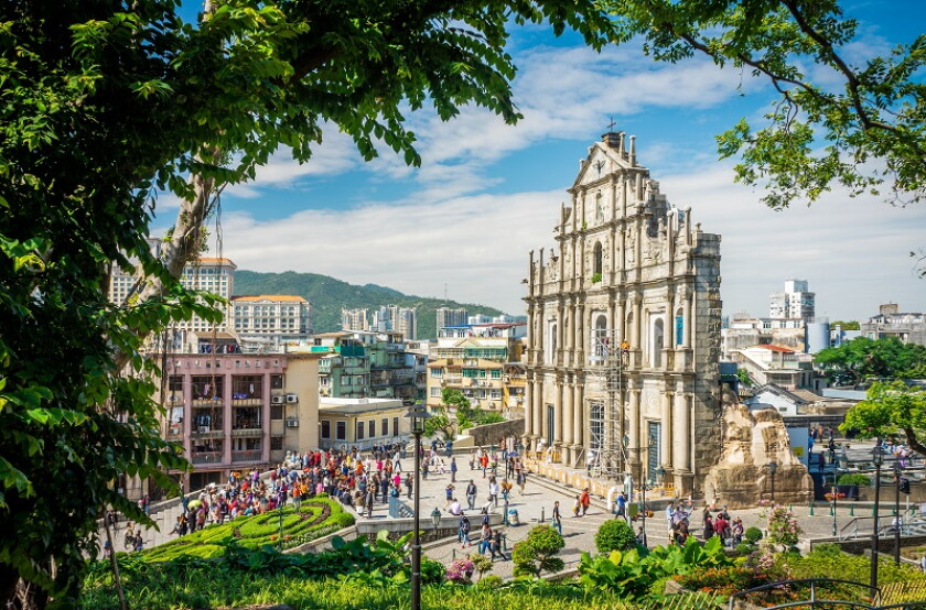 Ruins of Saint Paul's Catholic Church with tourists. They are one of Macau's famous landmarks.