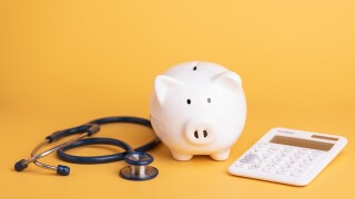 Financial for health concept, The idea of saving money for healthcare, Close up stethoscope and white piggy bank on yellow color copy space background. Health and finance concept