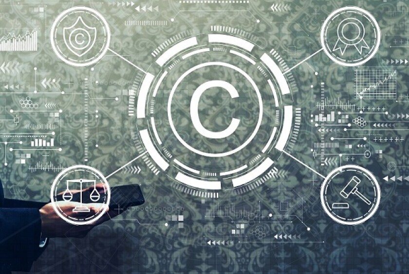 Copyright concept with businessman holding a tablet