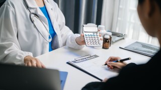 Healthcare costs and fees concept.Hand of smart doctor used a calculator and smartphone, tablet for medical costs