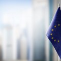 Small national flags of the European Union on a light blurry background